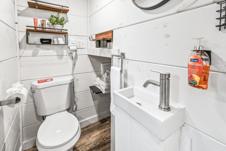 Bathroom in the tiny home with toilet and small sink