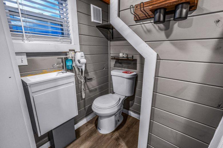 tiny home bathroom with toilet and sink in smoky mountains