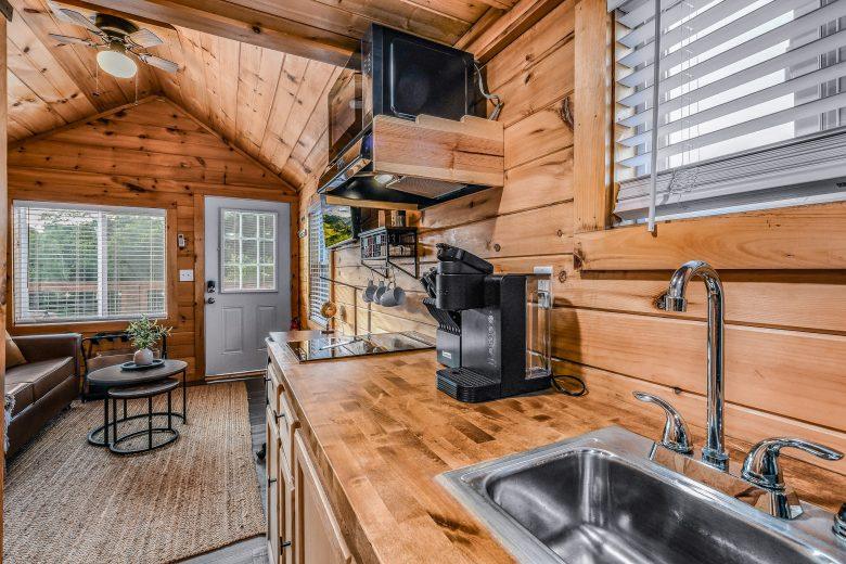 View of kitchenette with wooden cabinets, coffee maker, and stovetop